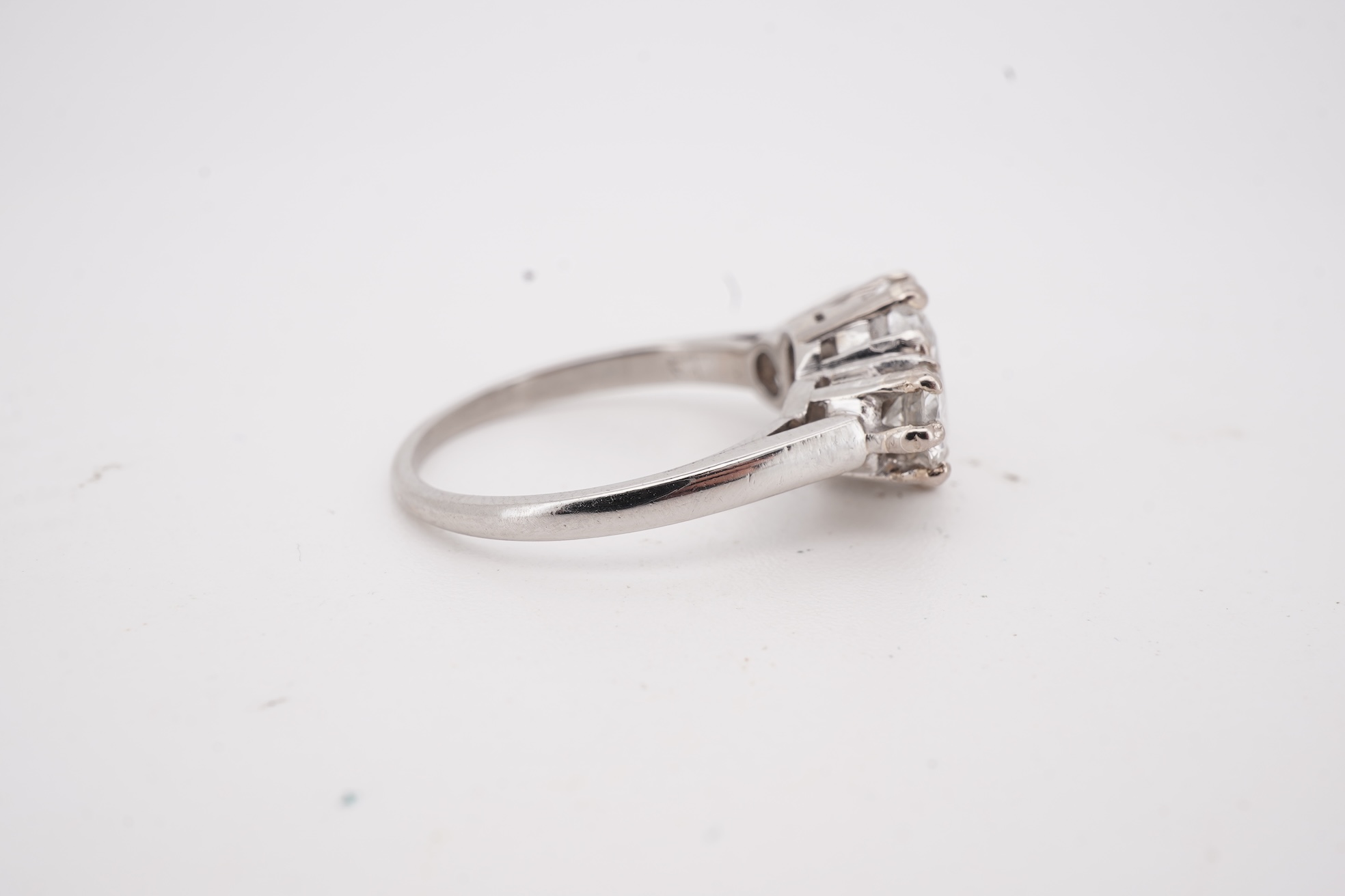 A diamond ring, set with a cushion-shaped diamond weighing 1.50 carats, between shoulders set with brilliant-cut diamonds totalling approximately 0.40 carats, size K, gross weight approximately 4 grams, Condition: centra